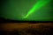 Two men on a chair watching Aurora borealis or Northern lights in Yellowknife, Canada, on August,