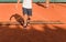 Two men clean tennis clay court
