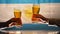 Two men clinking beer glasses against background with Argentinean flag, slow-mo