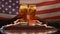Two men clinking beer glasses against USA flag, independence day celebration