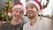 Two men couple celebrating christmas make selfie by camera at home