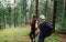 Two men create a video concentrate on a hike  a man shoots on camera as a friend flies a drone in a beautiful mountain forest.