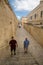 Two men descending stairs to passageway, Fort Manoel, Malta