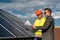 Two men discussing installation plan of new solar station. Green energy concept