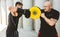 Two men exercising and fighting in outside. Boxer in gloves is training with a coach