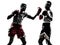 Two men exercising thai boxing silhouette