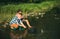 Two men friends fisherman fishing on river. Old father and son with rod fishing at riverside. Recreational activity