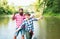 Two men friends fisherman fishing on river. Old father and son with rod fishing at riverside. Recreational activity.