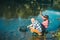 Two men friends fishing. Flyfishing angler makes cast, standing in river water. Old and young fisherman. Catching trout