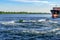 Two men have fun while riding jet skis in the Dnieper River near the Kherson embankment.