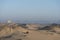 Two men having a breakfast tea next to their jeep 4x4 Landcruiser in the Egyptian desert with the mountains of the Western desert