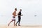 Two Men Jogging On Beach Together Guys Runners Training On Seaside Sport Fitness Workout Outdoors