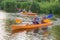 Two men on a kayak, tourists rafters in a blue boat, Matrosovka river