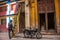 Two men and a ladder repairing wiring at home, the motorcycle is parked on the street. Havana. Cuba.