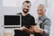 Two Men with Laptop in Workshop in Repair Shop.