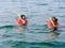 Two men in the life vests and masks