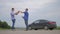 Two men make deal. man handshake hands over the keys seller driver makes car the auto insurance slow motion video sale