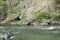 Two men navigate a rocky river in remote Alaska