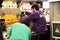 Two men prepare freshly squeezed natural juice, food court in the central market