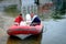 Two men in red rubber rescue boat checking boat on the bay