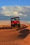 Two Men Riding a Four Wheeler Through Beautiful Sand