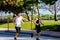 Two men running on Ocean Drive Miami Beach action shot street photography