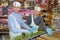 Two men serving at food counter