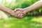 Two men shaking hands against nature background