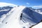 Two men snowshoe hiking on mountain snow arete and panorama in Stubai Alps