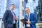 Two men in suits with clipboard and keys negotiate