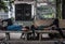 Two men are taking a nap on a bench on a quiet alley in Ho Chi Minh City, Vietnam.