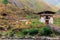 Two men taking photo near the Iron Bridge of Tamchog Lhakhang Monastery, Paro River, Bhutan.