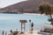 Two men taking photos of Panormos Beach sign, Mykonos, Greece