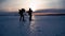 Two men tourist with backpacks are in the mountains in the winter against snow covered. Two friends travel together in