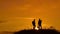 Two men tourists hikers silhouette go to the mountains sunset travel slow motion video. Traveler successful young men