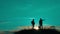 Two men tourists hikers silhouette lifestyle go to the mountains sunset travel slow motion video. Traveler successful