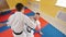Two men training their aikido skills. Training their fighting. Protecting from a leg hit and throwing the opponent on