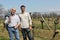 Two men trimming bare vines