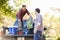 Two Men Unpacking Pick Up Truck On Camping Holiday