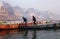 Two Men Walk Across Boats Varanasi