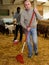 Two men working in goat barn