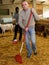 Two men working in goat barn