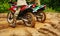 Two mens on a motorcycle rides through the mud