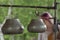 Two metal cauldrons hanging upside down as musical instruments.