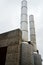 Two metal chimney against the gray sky