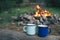 Two metal cups with tea. fire on background