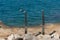 Two metal showers on the beach coast of the Adriatic sea. Eco-friendly beaches marked with a blue flag