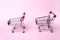 Two metal supermarket trolleys in miniature. Shopping, purchases, supermarket, sale, mall concept. Grocery supermarket, food and