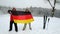 Two middle-aged men sport fans waving Germany flag