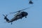 Two Military choppers shooting machine guns in combat and war flying into the smoke and chaos and destruction. Military concept of